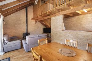 a living room with a table and a couch at Riverscape Cottages in Augusta