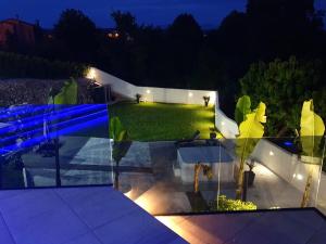 a view of a garden at night with lights at Jacuzzi Penthouse Apartment in Matulji