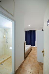 a bathroom with a tub and a toilet and a shower at Mema Rooms in Himare