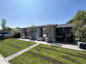 a house with a yard with a lawn sidx sidx sidx at Beach Resort Nieuwvliet-Bad 1240 - EEZZ in Nieuwvliet
