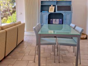 a blue table with chairs and a box on it at Appartamento in Villa Mimosa in Cervo