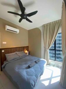 a bedroom with a bed with a ceiling fan at MUJI Home KL in Kuala Lumpur
