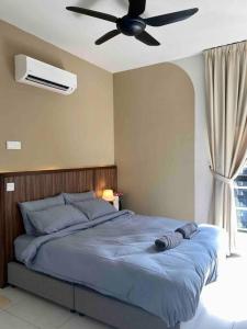a bedroom with a bed with a ceiling fan at MUJI Home KL in Kuala Lumpur