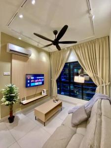 a living room with a couch and a ceiling fan at MUJI Home KL in Kuala Lumpur
