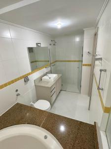 a bathroom with a toilet and a sink and a shower at Saint Sebastian Flat 307 - Com Hidro! até 4 pessoas, Duplex, no centro in Jaraguá do Sul