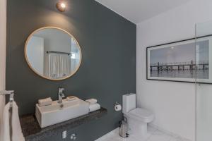 a bathroom with a sink and a mirror at Monochromatic 2BR in Miraflores in Lima