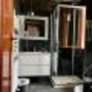 a kitchen with a white refrigerator and cabinets at Residence Paradiso Monolocale 206 in Moneglia +2 photos