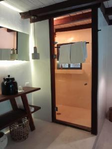 a wooden door in a room with a table at Amor Rooms in Tulum