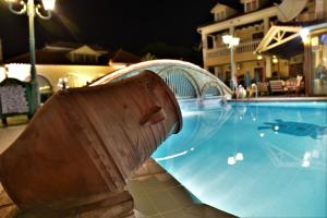 a large swimming pool with a plastic ramp around it at Elpida Hotel in Alikanas