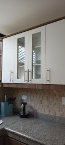 a kitchen with white cabinets and a counter top at Casa David in Riobamba