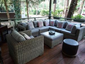 a patio with wicker couches and a table at Chalet in Lanaken