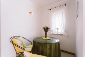 a table with a vase of flowers on it in a room at Best Houses 84 - Mar Salgado in Ferrel