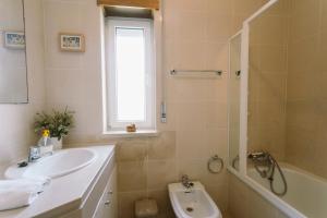 a bathroom with a sink and a shower and a tub at Best Houses 84 - Mar Salgado in Ferrel +21 photos