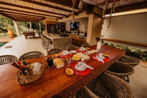 a wooden table with plates of food on top of it at Beach House Sauípe in Costa do Sauipe