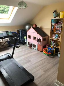 a room with a room with a house and a treadmill at Meadow House in County Donegal in Donegal