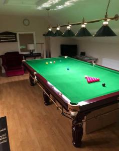 a pool table with balls on it in a living room at Meadow House in County Donegal in Donegal