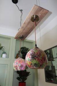 three glass balls hanging from a ceiling at The Old Schoolhouse in Whitstable