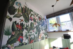 a wall with a mural of flowers and plants at The Old Schoolhouse in Whitstable