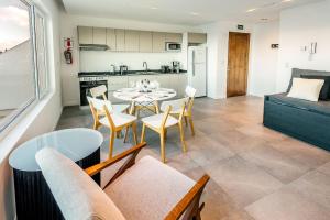 a kitchen and a living room with a table and chairs at Gente del Sur - Urbano Centro in Ushuaia