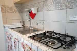 a stove top in a kitchen with a sink at Ilios in Tropea