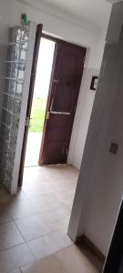 an open door to a room with a door at Apartamento Rosa in Porto Covo