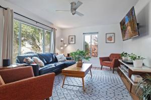 a living room with a blue couch and a table at Mid-century, modern oasis, fully stocked in Murray