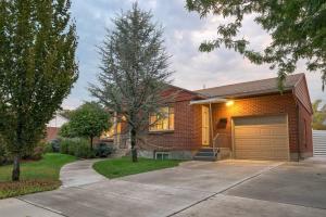 a brick house with a garage and a driveway at Mid-century, modern oasis, fully stocked in Murray