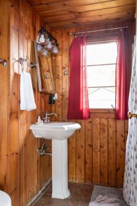 a bathroom with a sink and a window at Lee Point Classic Cabins on West Bay with Hot Tub in Suttons Bay