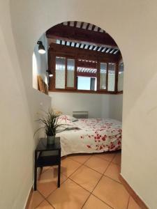 a bedroom with a bed and a window and a table at CORDELIERS MAIRIE in Aix-en-Provence