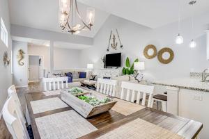 a dining room and living room with a table and chairs at Carpe BeachBum in Port Aransas