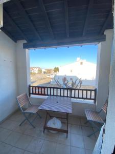 a patio with a table and chairs on a balcony at Appartement Duplex Climatisé Le Trident in Saintes-Maries-de-la-Mer