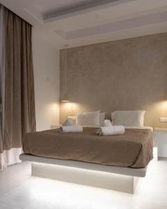 a bedroom with a large bed with two white pillows at Dedalos Studios Naxos in Naxos Chora