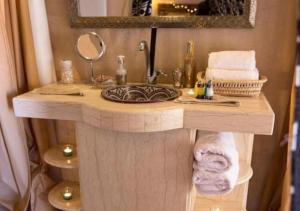 a bathroom vanity with a sink and a mirror at Merzouga dreams Camp in Erfoud