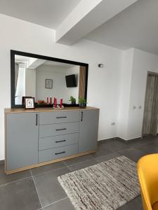 a room with a dresser with a large mirror at Apartamente Ariniș in Gura Humorului