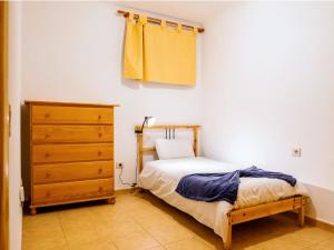 a small bedroom with a bed and a dresser at Live Puertito Almirante in Puertito de Güímar