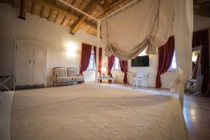 a bedroom with a large bed with a canopy at Villa Nena in Tolentino