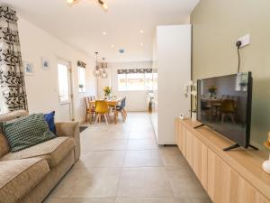 a living room with a couch and a television at Seaside House in Great Yarmouth