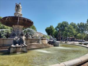 a fountain in a park with two statues in the water at ROTONDE BONAPARTE in Aix-en-Provence