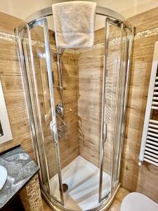 a shower with a glass enclosure in a bathroom at Casa Zeffirino in Sanremo