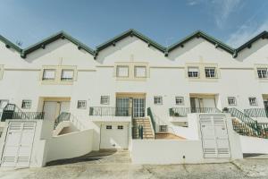 an exterior view of a large white building at Best Houses 81 - Sea La Vie in Atouguia da Baleia