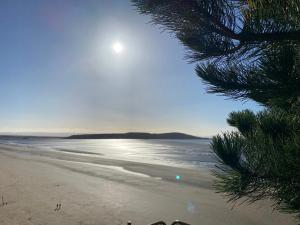 a view of a beach with the sun and the ocean at The Retreat in Weston-super-Mare