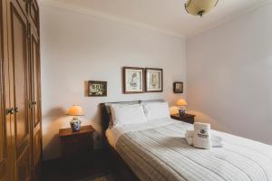 a bedroom with a bed with two lamps on tables at Best Houses 81 - Sea La Vie in Atouguia da Baleia