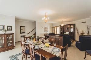 a kitchen and dining room with a table and chairs at Best Houses 81 - Sea La Vie in Atouguia da Baleia