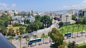 an aerial view of a city with buses on a street at Apartamento en Residencia Brooks Iberia in Tangier