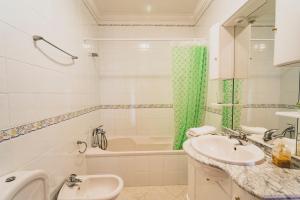 a bathroom with a sink and a tub and a toilet at Best Houses 81 - Sea La Vie in Atouguia da Baleia +29 photos