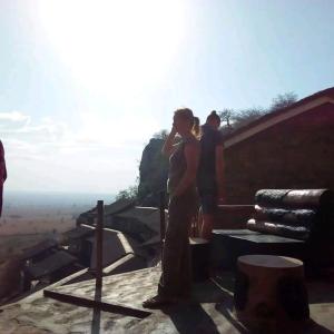 a woman standing at the top of a mountain at Katurum Kidepo lodge in Loitanit