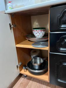 a cupboard with a bowl and dishes in it at Дачный Домик на берегу озера Балхаш in Balqash