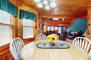 a dining room with a wooden table and chairs at Our Mountain Blessing - STR License #026,912 in Mashburn Mill
