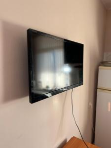 a flat screen tv hanging on a wall at Дачный Домик на берегу озера Балхаш in Balqash