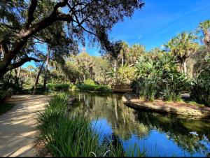 a pond in a park with trees and water at Hammock Beach 2BD 2BR Villa! Walk to the Ocean! in Palm Coast